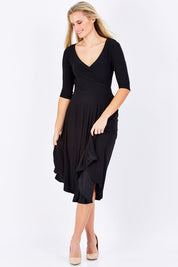 Model Maddy wearing size 10 of the Stella Dress in colour Black (Black), from the front, showing the whole outfit