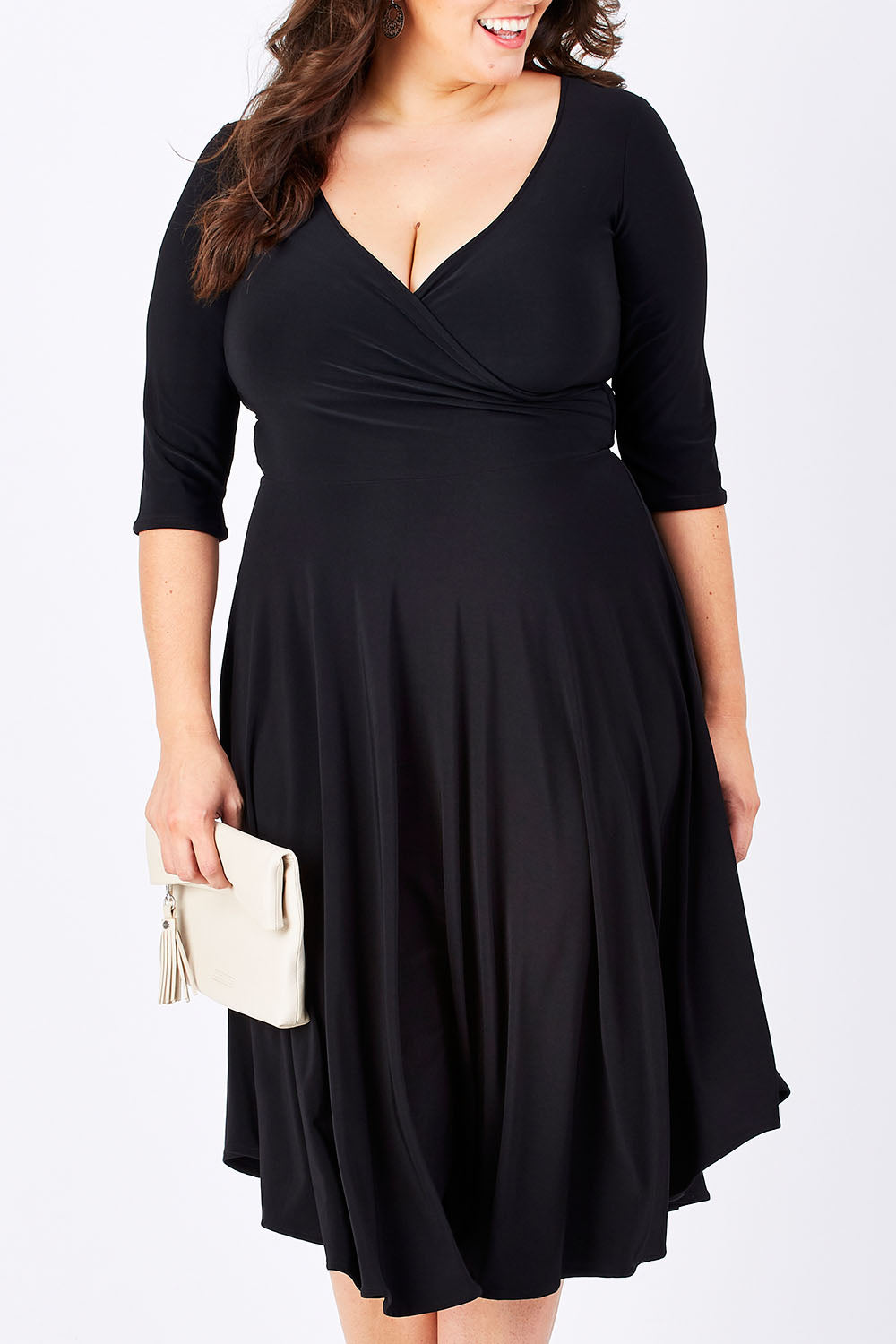 Model Mae wearing size 16 of the Stella Dress in colour Black (Black), from the front, cropped image