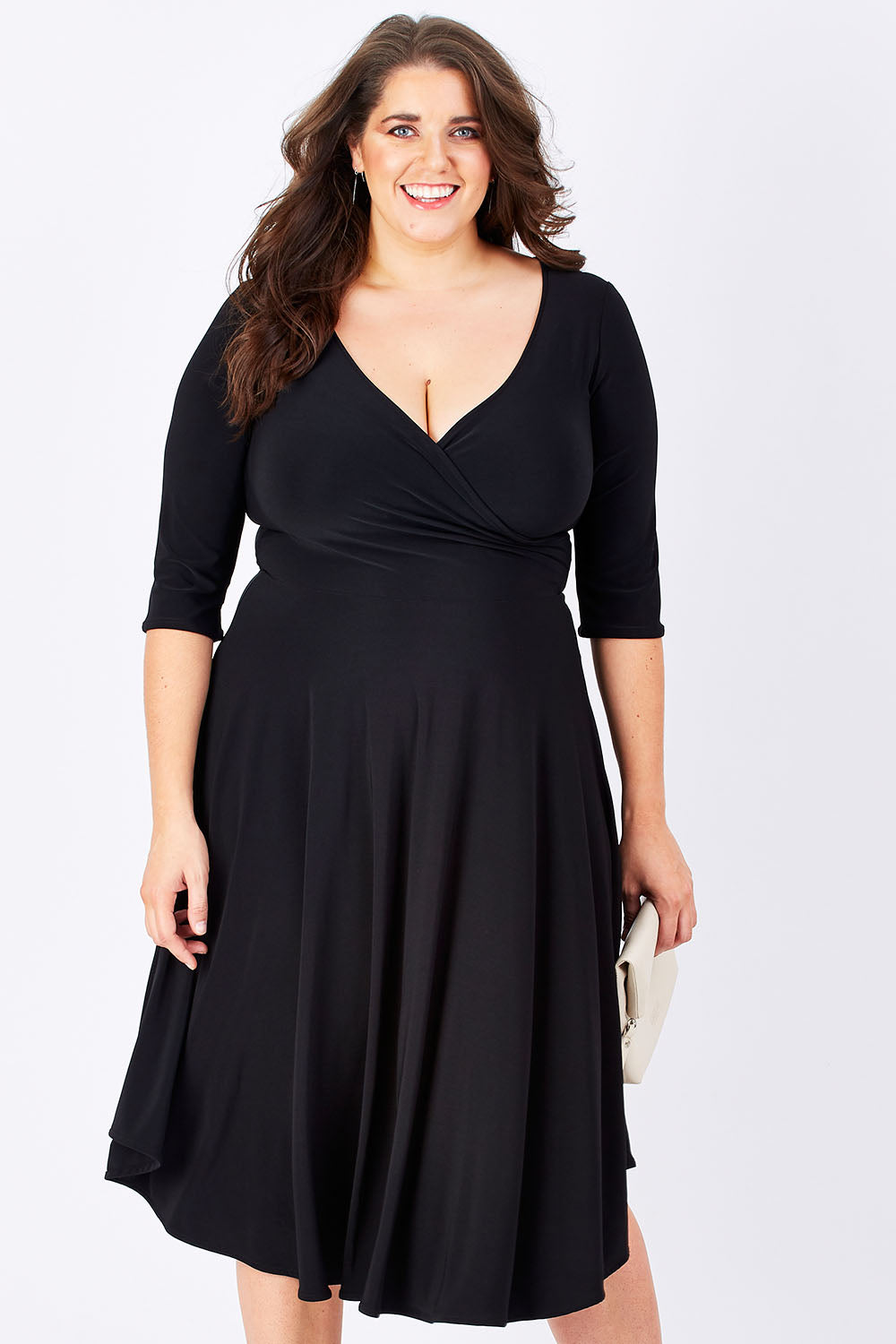 Model Mae wearing size 16 of the Stella Dress in colour Black (Black), from the front, cropped image