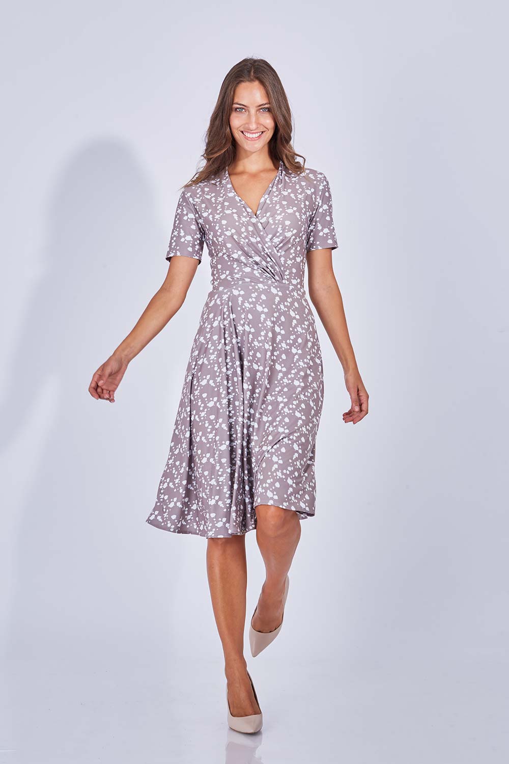 Model Anna wearing size 10 of the Flora Dress in colour Sand, from the front, showing the whole outfit