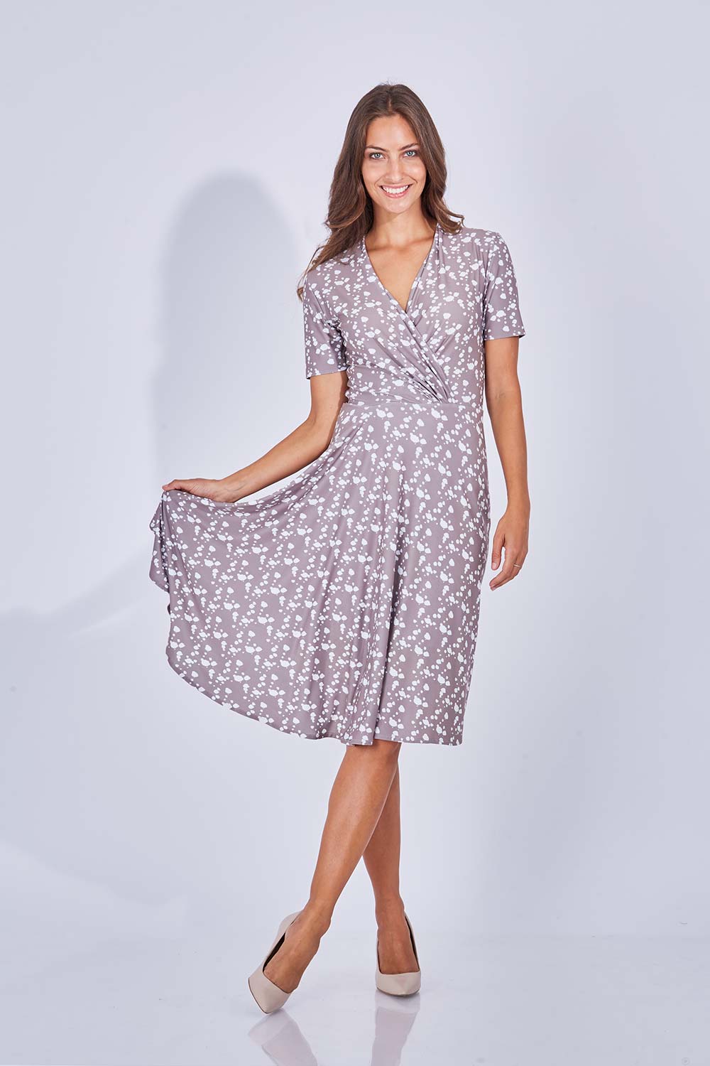 Model Anna wearing size 10 of the Flora Dress in colour Sand, from the front, showing the whole outfit