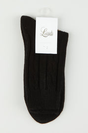 A model wearing size OneSize of the Nina Cable Crew Sock in colour Nero (Black), from the front, showing the whole outfit
