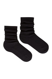 Product shot of the Slouchy Sock in colour Nero (Black), from the front