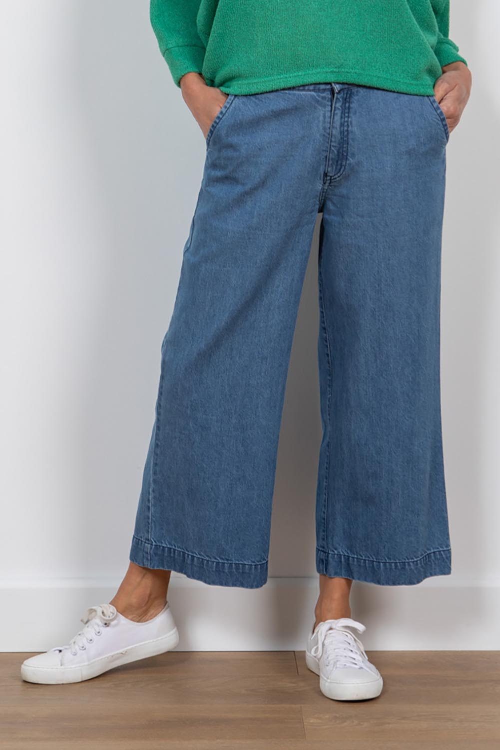 A model wearing the Ruby Crop Jeans in colour Denim (Blue), from the front, cropped image
