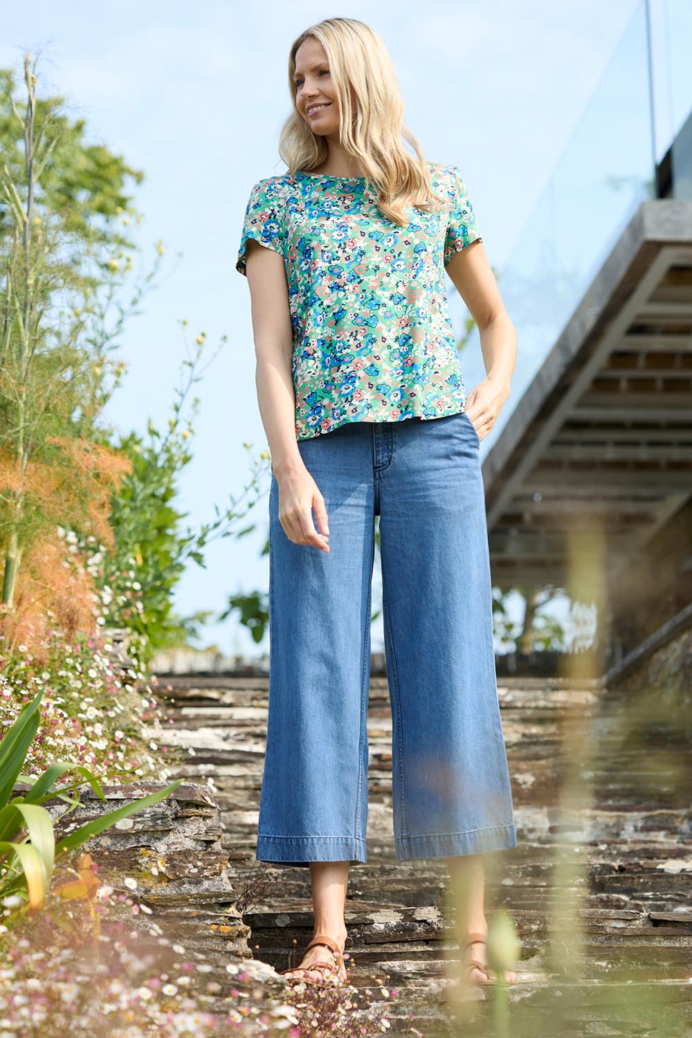 A model wearing the Ruby Crop Jeans in colour Denim (Blue), from the front, showing the whole outfit