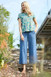 A model wearing the Ruby Crop Jeans in colour Denim (Blue), from the front, showing the whole outfit