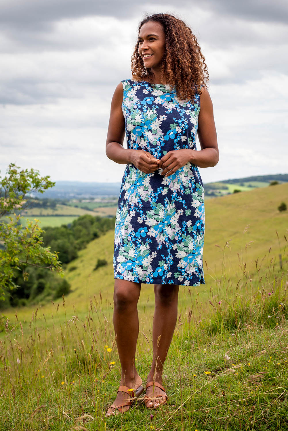 A model wearing the Annie Dress in colour Navy (Blue), from the front, showing the whole outfit