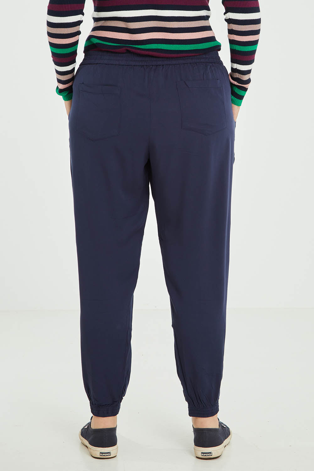 Model Jess wearing size 16 of the Tetbury Trouser in colour Navy (Blue), from the back