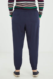 Model Jess wearing size 16 of the Tetbury Trouser in colour Navy (Blue), from the back