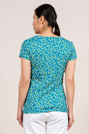 A model wearing the Cockles Tee in colour Teal (Blue), from the back