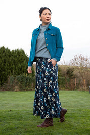 A model wearing the Frome Skirt in colour Navy (Blue), from the front, showing the whole outfit