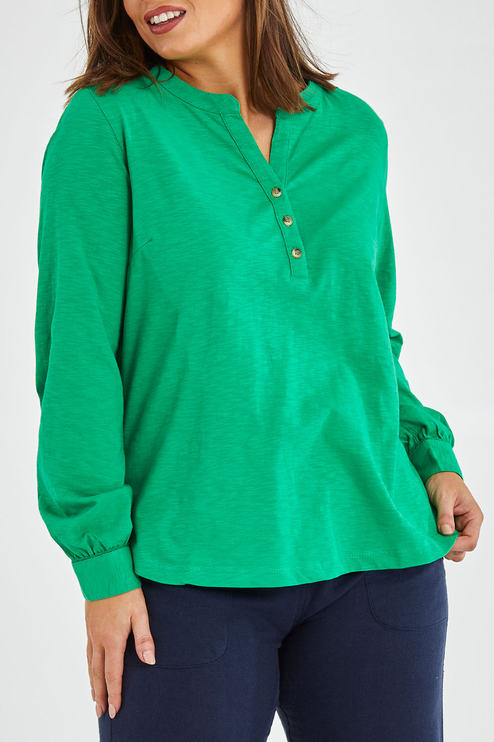 Model Monique wearing size 14 of the Peony Top in colour Bgreen (Green), from the front, cropped image