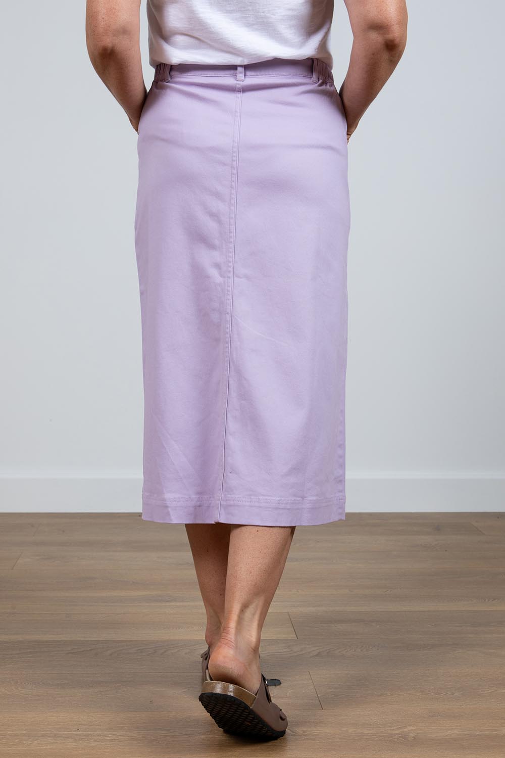 A model wearing the Rosanna Skirt in colour Lavender (Purple), from the back