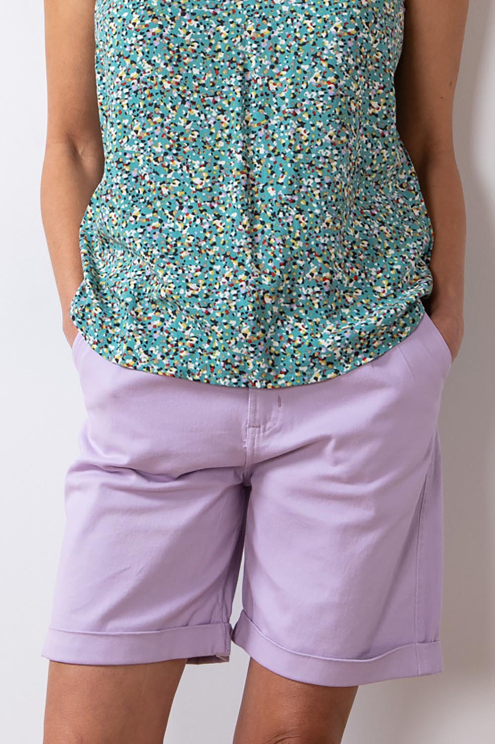 A model wearing the Marine Twill Short in colour Lavender (Purple), from the front, cropped image