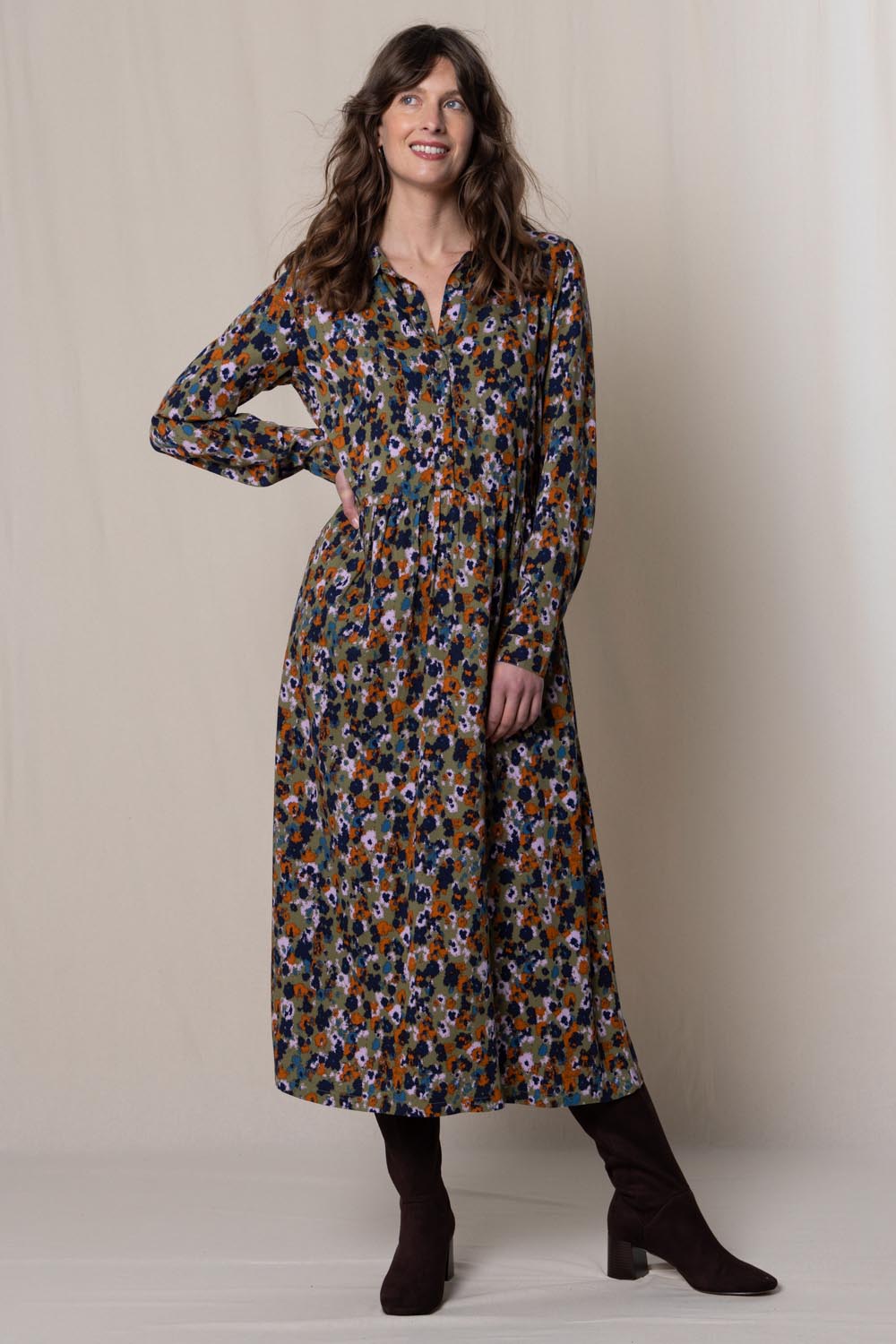 A model wearing the Seasons Dress in colour Olive (Green), from the front, showing the whole outfit
