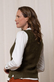 A model wearing the Laurel Tank in colour Olive (Green), from the back
