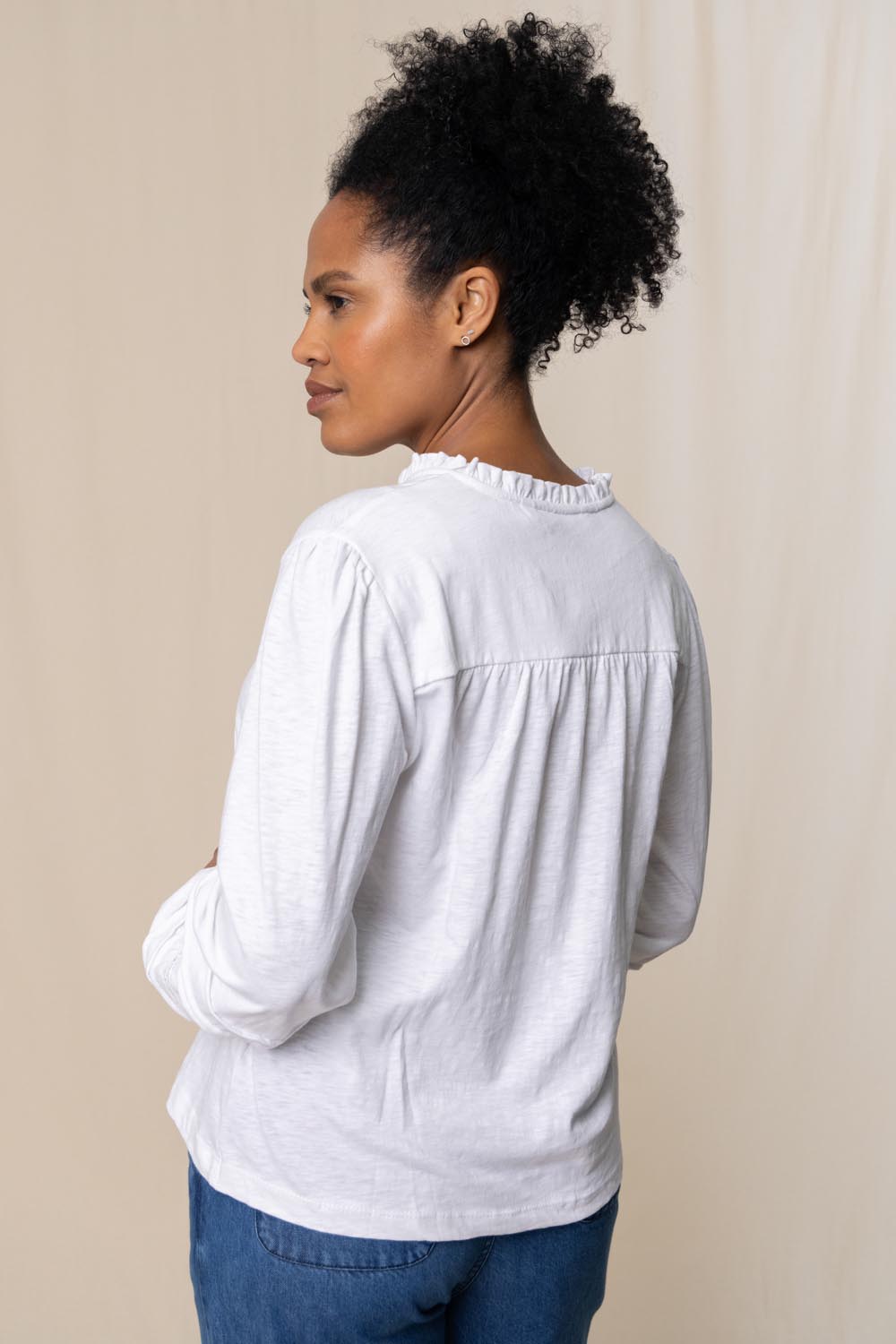 A model wearing the Bette Cotton Top in colour White (White), from the back
