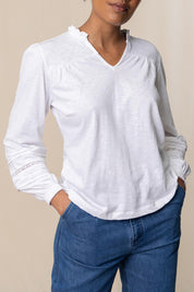 A model wearing the Bette Cotton Top in colour White (White), from the front, cropped image