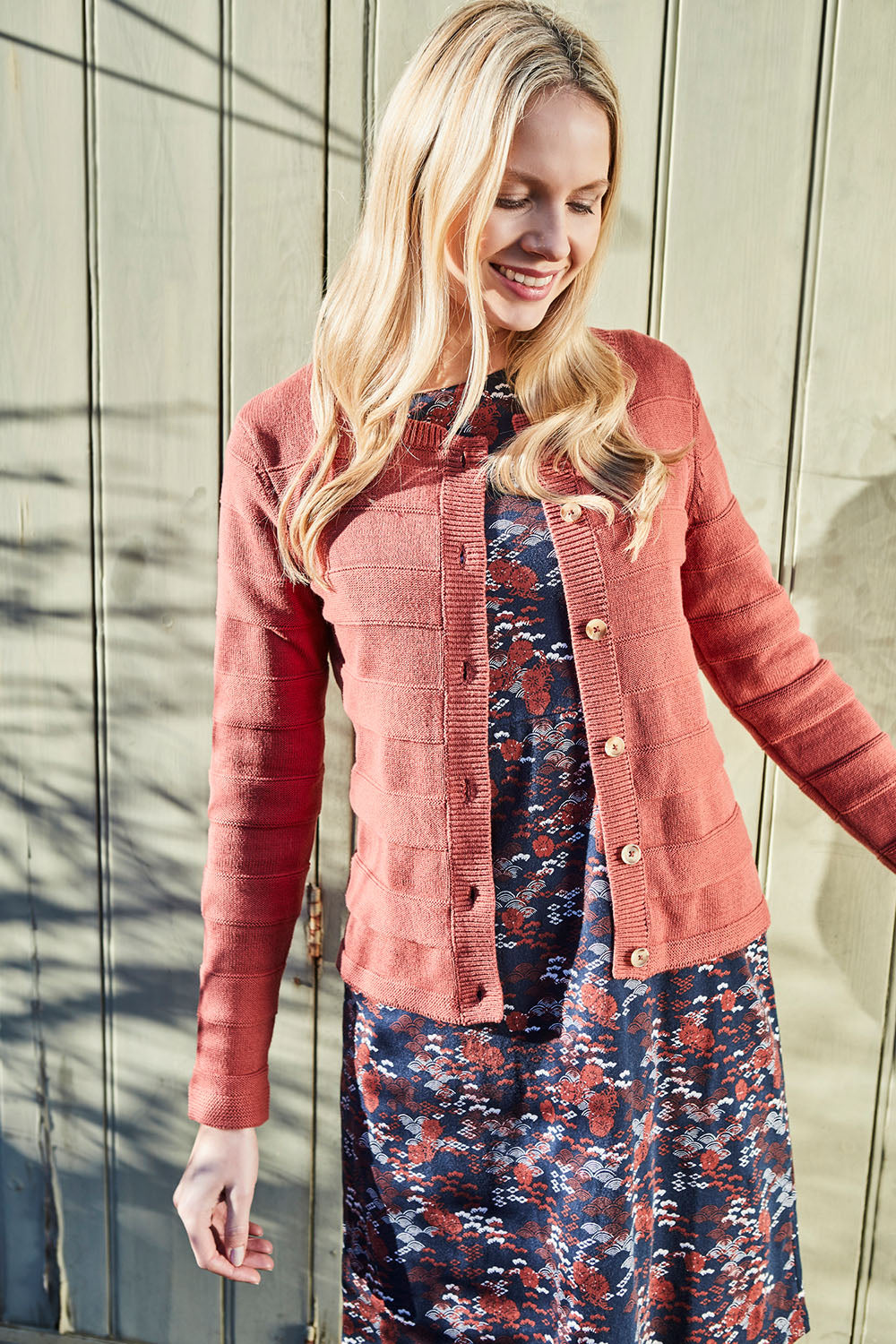 A model wearing the Gabriella Knit Cardi in colour Softbrick, from the front, showing the whole outfit