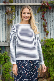 A model wearing the Meadow Stripe Jumper in colour Navystri (Blue), from the front, showing the whole outfit
