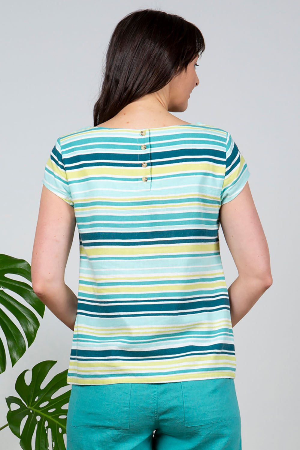 A model wearing the Sun And Shade Top in colour Tealstrip (Green), from the back