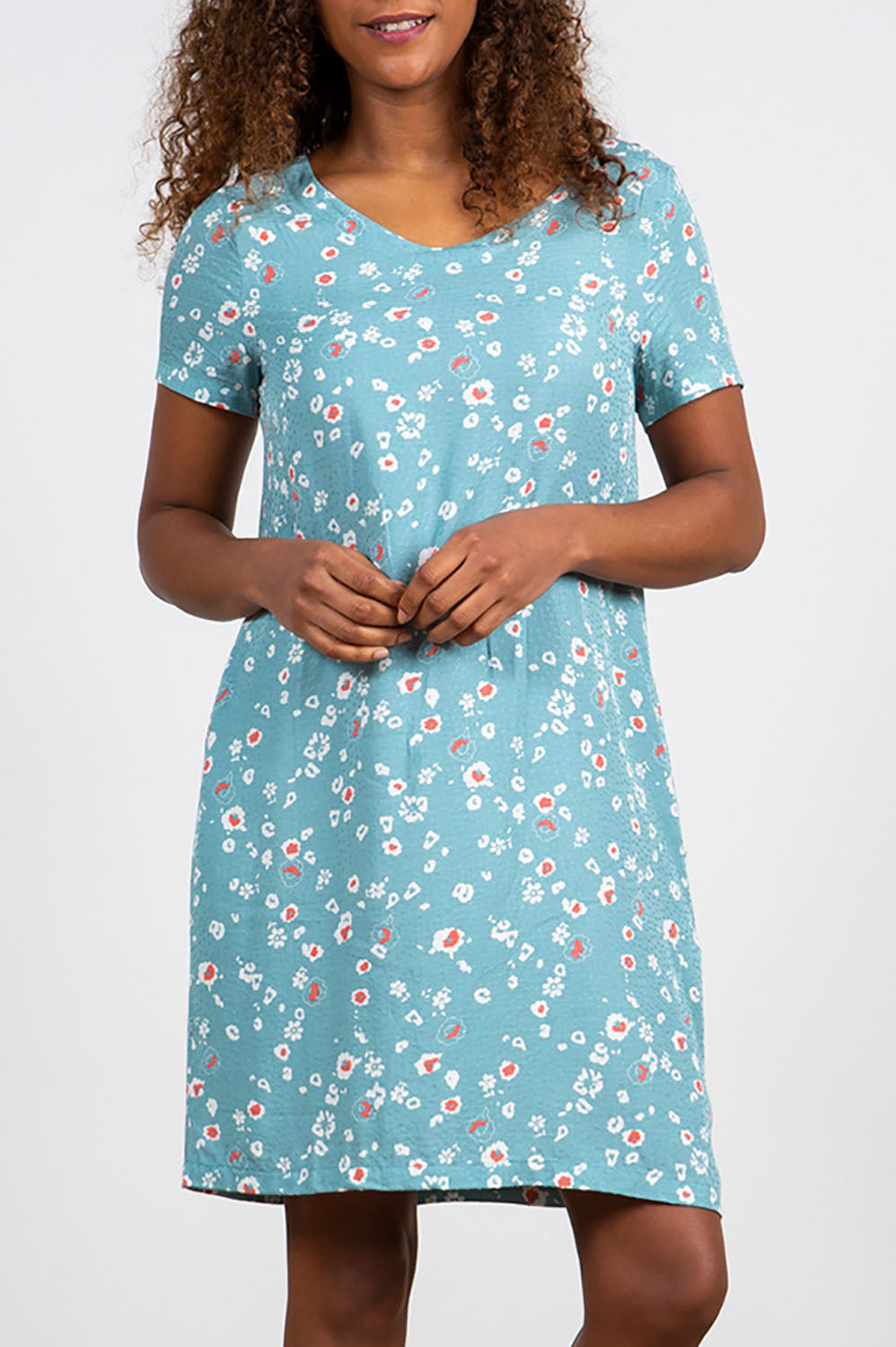 A model wearing the Seascape Dress in colour Seafoam (Blue), from the front, cropped image