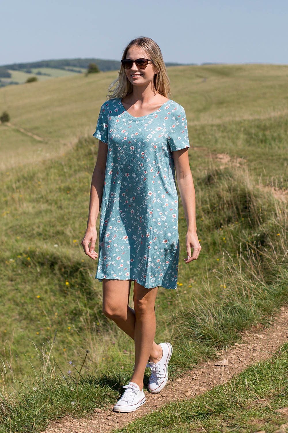 A model wearing the Seascape Dress in colour Seafoam (Blue), from the front, showing the whole outfit