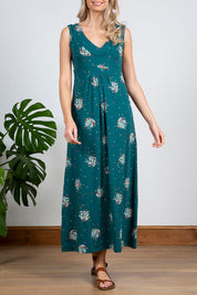 A model wearing the Chrissy Maxi Dress in colour Darkteal (Green), from the front, cropped image