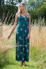 A model wearing the Chrissy Maxi Dress in colour Darkteal (Green), from the front, showing the whole outfit
