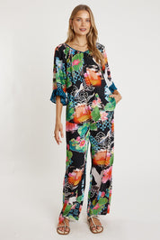 A model wearing the Akiko Pant in colour Ocean, from the front, showing the whole outfit