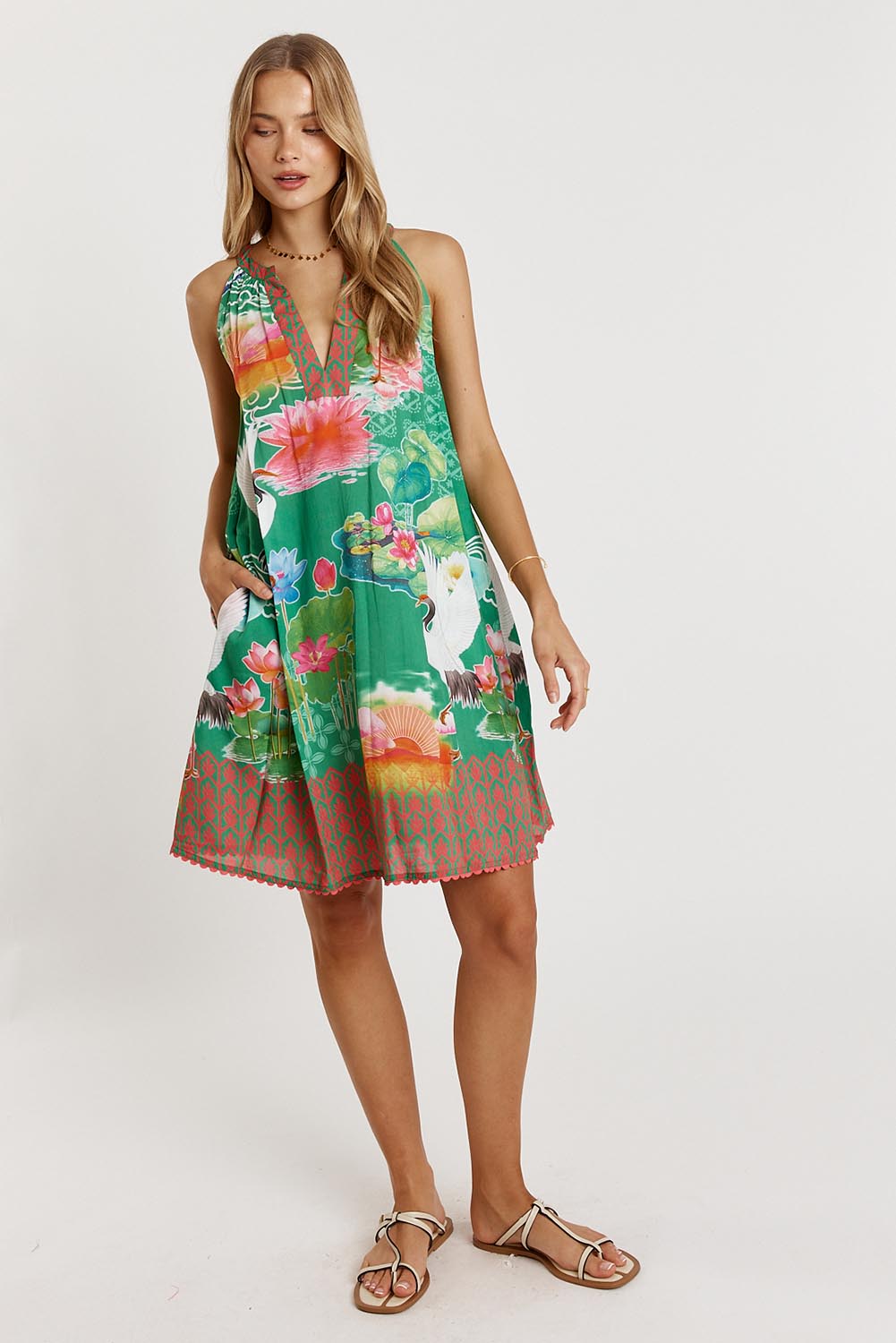 A model wearing the Akiko Sundress in colour Sea (Green), from the front, showing the whole outfit
