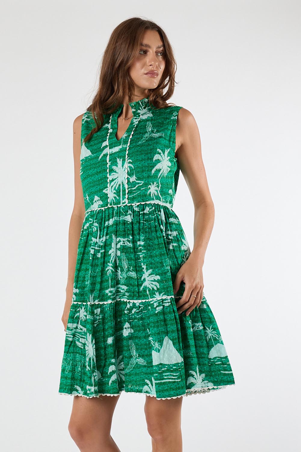 Model Genericm wearing size sample of the Alura Sundress – Lagoon in colour Lagoon, from an angle