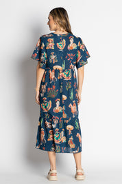 A model wearing the Arriba Cotton Midi Dress in colour Navy (Blue), from the back