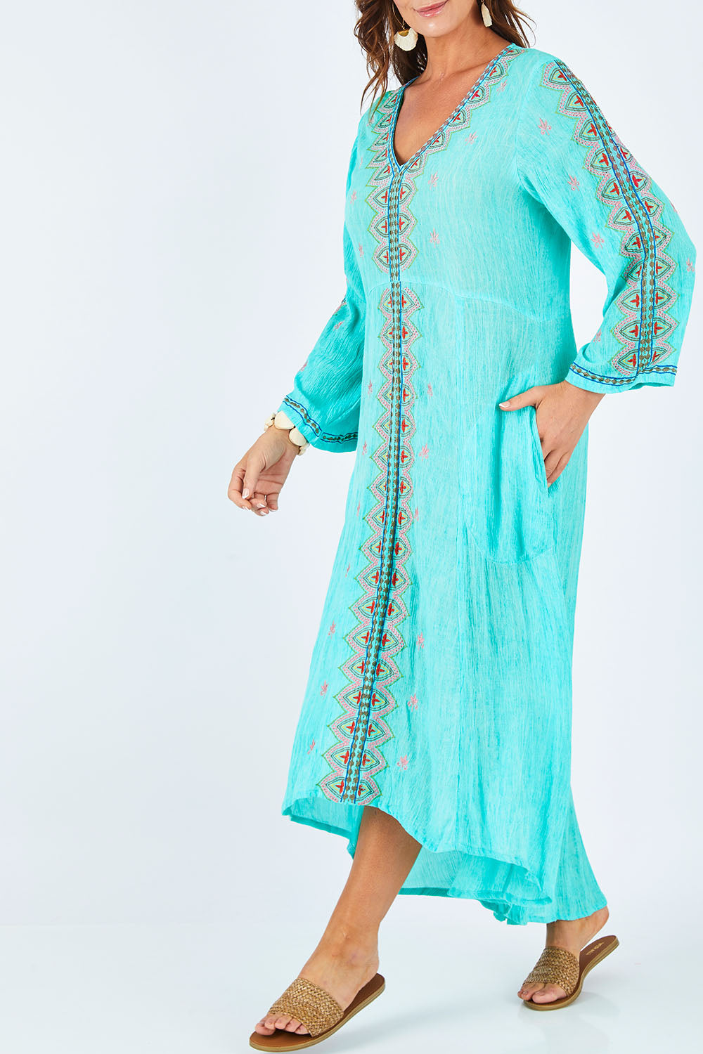 Model Abby wearing size L of the Brazil Dress in colour Aqua (Blue), from the front, cropped image