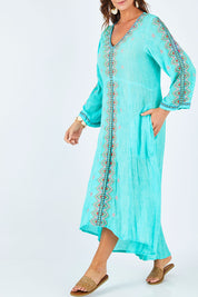 Model Abby wearing size L of the Brazil Dress in colour Aqua (Blue), from the front, cropped image