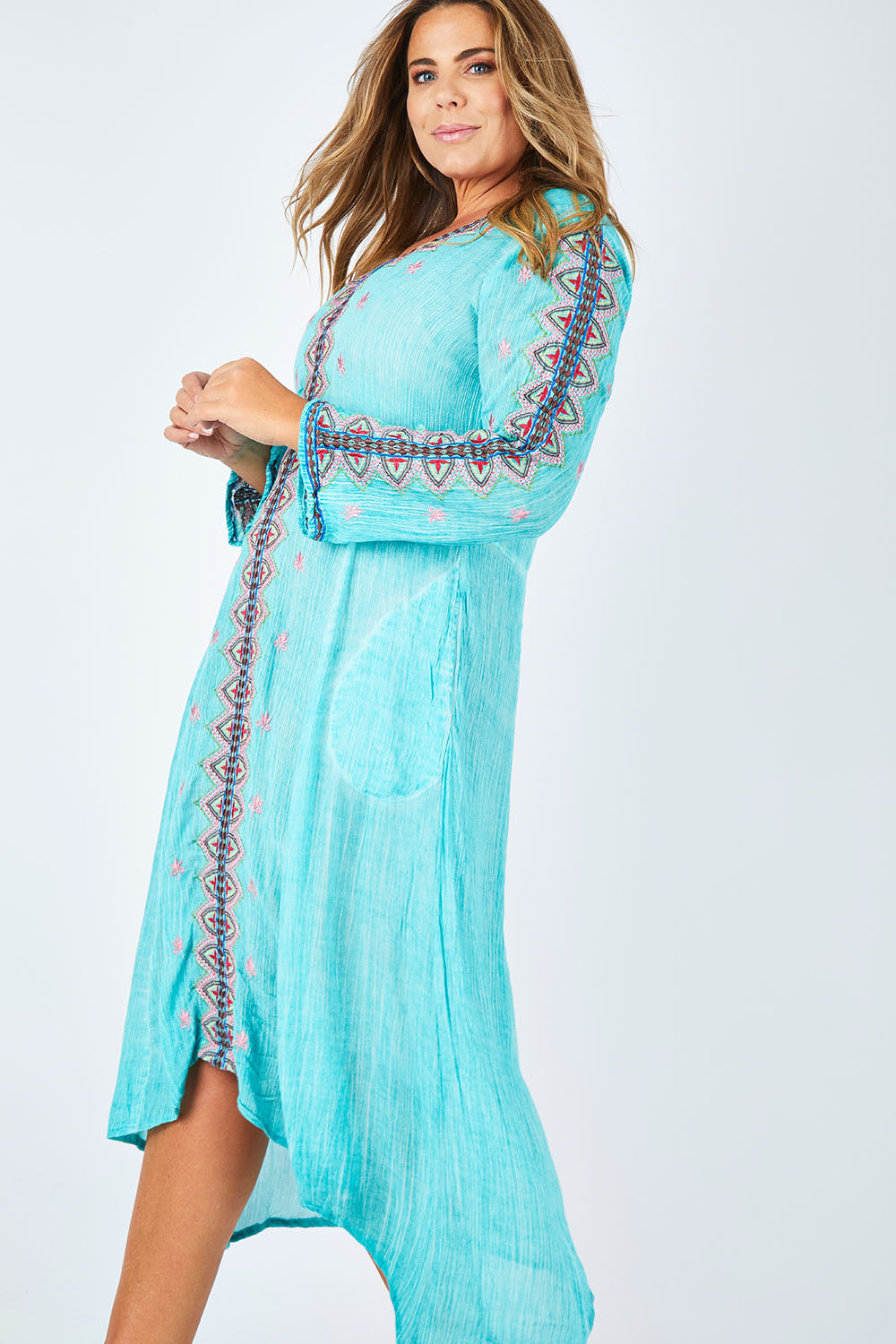 Model Fiona wearing size XL of the Brazil Dress in colour Aqua (Blue), from the front, cropped image