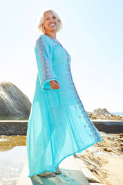 Model Michelle wearing size M of the Brazil Dress in colour Aqua (Blue), from the front, showing the whole outfit