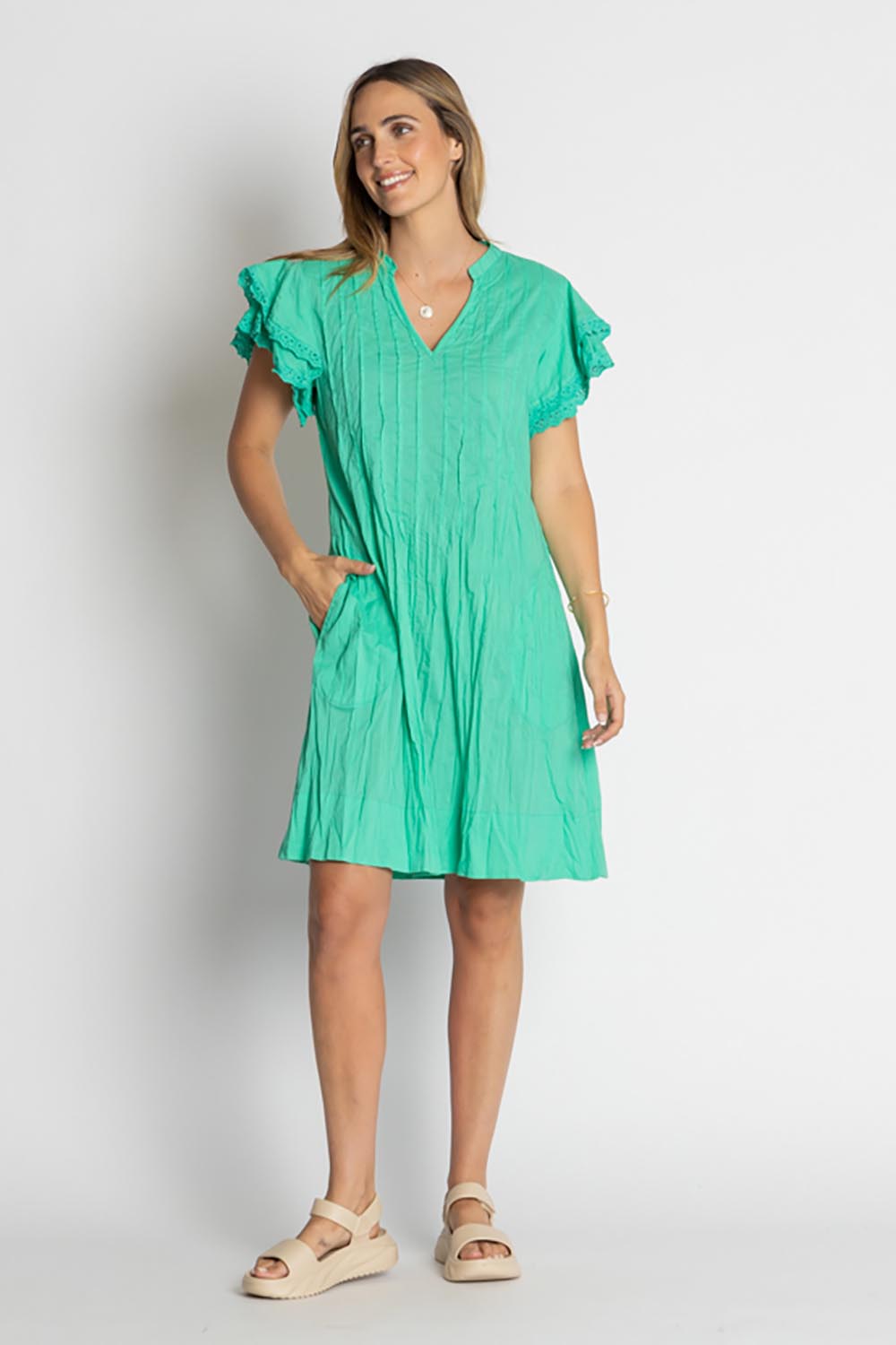 A model wearing the Celeste Ruffle Cotton Dress in colour Sea (Blue), from the front, showing the whole outfit