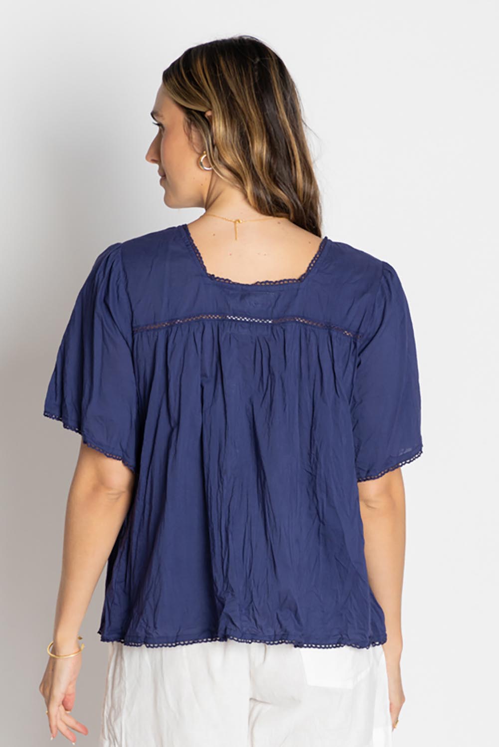 A model wearing the Celeste Cropped Cotton Top in colour Navy (Blue), from the back