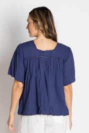 A model wearing the Celeste Cropped Cotton Top in colour Navy (Blue), from the back