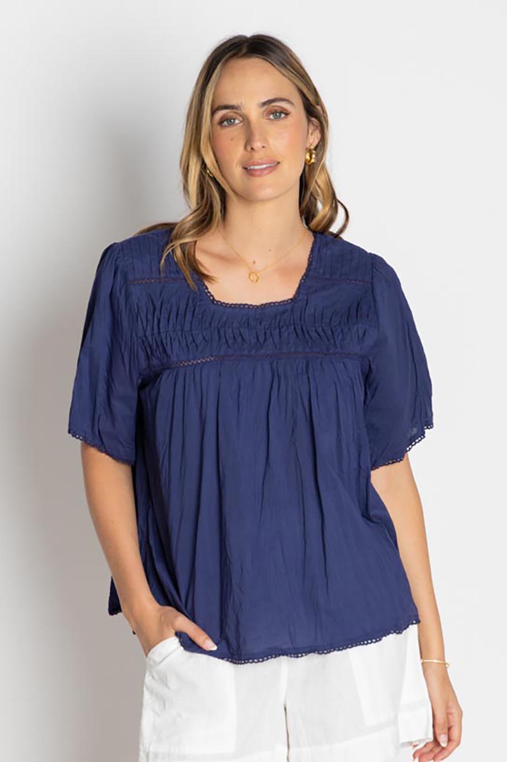 A model wearing the Celeste Cropped Cotton Top in colour Navy (Blue), from the front, cropped image