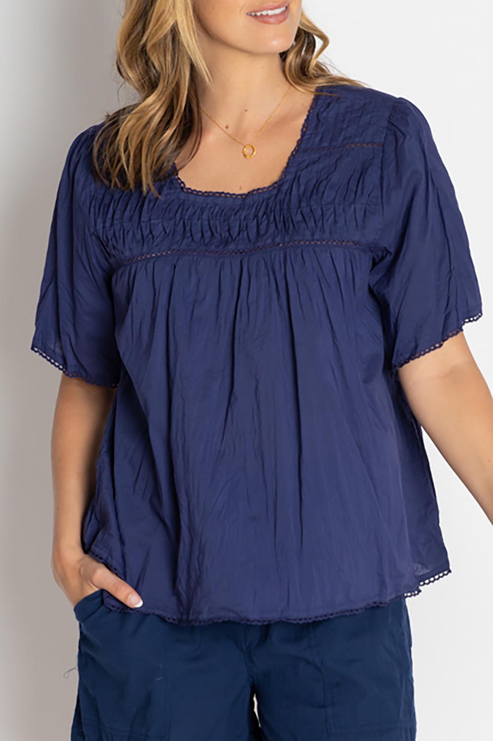 A model wearing the Celeste Cropped Cotton Top in colour Navy (Blue), from the front, cropped image
