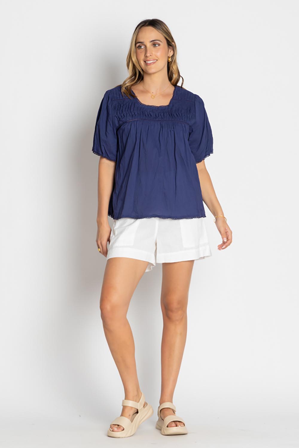A model wearing the Celeste Cropped Cotton Top in colour Navy (Blue), from the front, showing the whole outfit