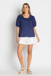 A model wearing the Celeste Cropped Cotton Top in colour Navy (Blue), from the front, showing the whole outfit