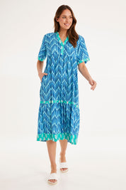 Model Madeline wearing size S of the Chevron Midi Dress in colour Ocean (Blue), from the front, showing the whole outfit