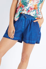 Model Gemma wearing size S of the Coconut Short in colour Indigo (Blue), from the front, cropped image
