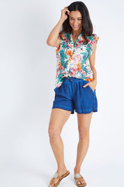Model Gemma wearing size S of the Coconut Short in colour Indigo (Blue), from the front, showing the whole outfit