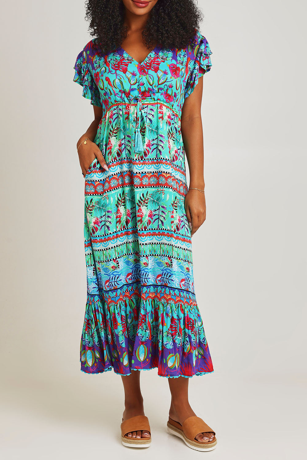 Model Ziara wearing size S of the Elisie Midi Dress in colour Sea (Blue), from the front, cropped image