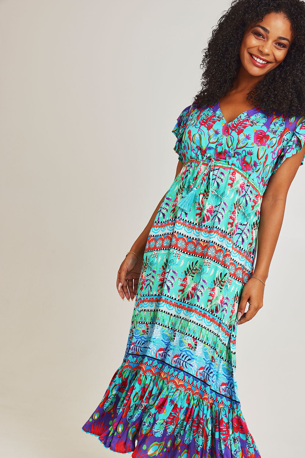 Model Ziara wearing size S of the Elisie Midi Dress in colour Sea (Blue), from the front, cropped image