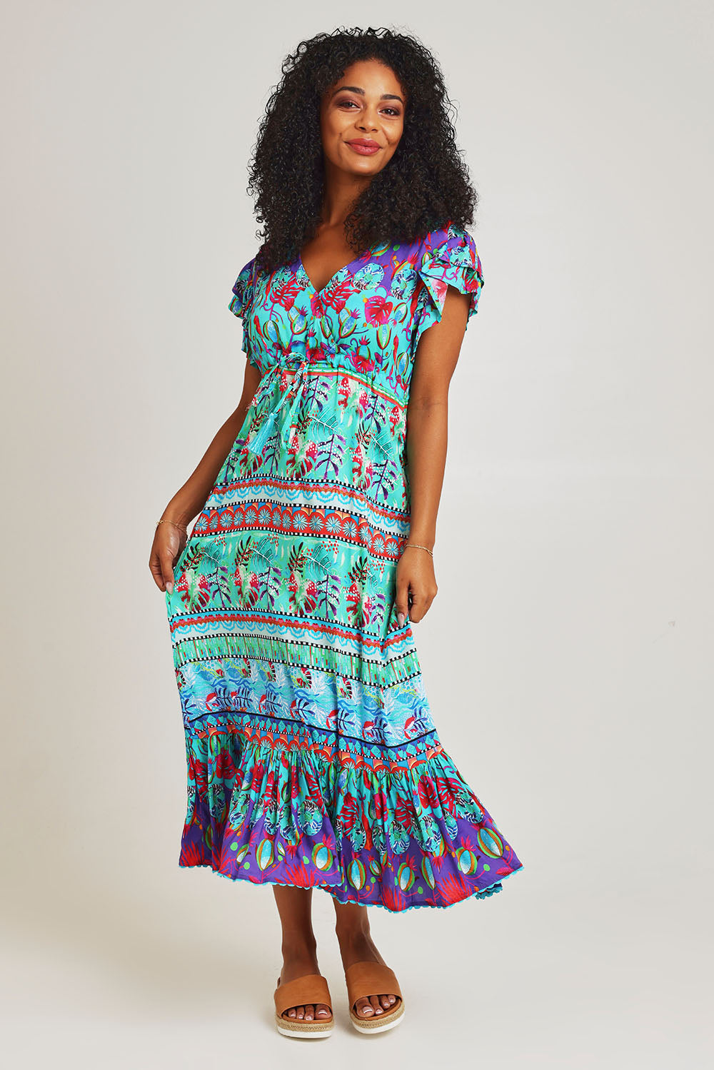 Model Ziara wearing size S of the Elisie Midi Dress in colour Sea (Blue), from the front, showing the whole outfit